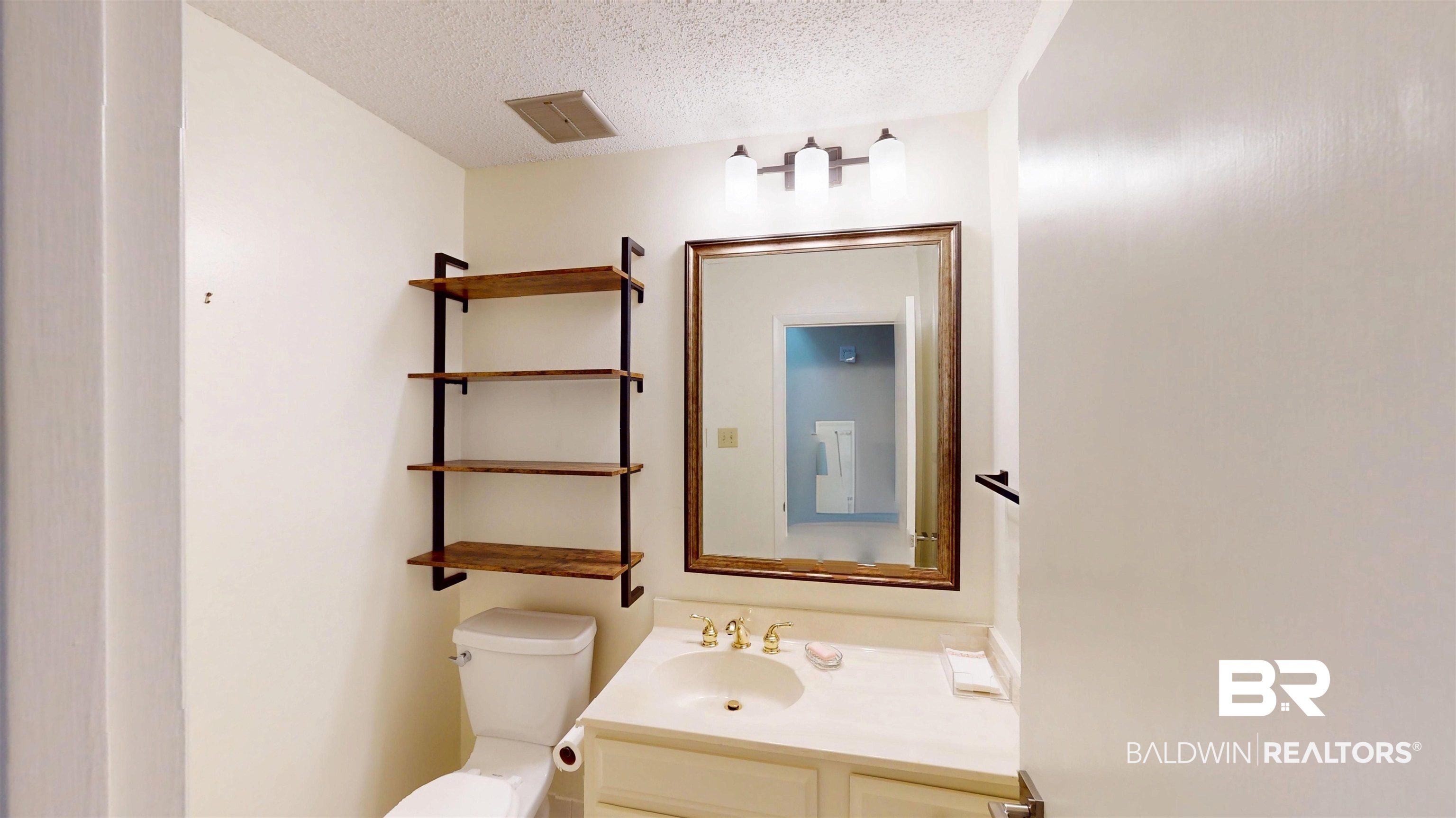 2901 Grant Street, Unit 902 Mobile, AL 36606 - Photo 12 of 35 Bathroom featuring vanity and a textured ceiling