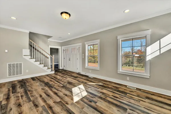 a large white kitchen with cabinets