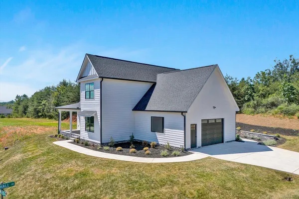 a view of house with backyard