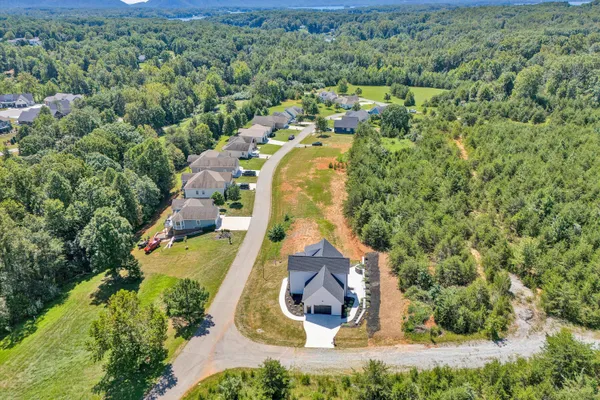 an aerial view of a house with yard swimming pool and outdoor seating