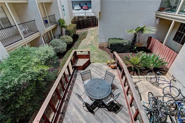 a backyard of a house with wooden floor and outdoor seating