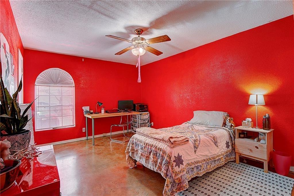 910 Duncan Lane, Unit 7 Austin, TX 78705 - Photo 3 of 20 a bedroom with a bed and a chandelier