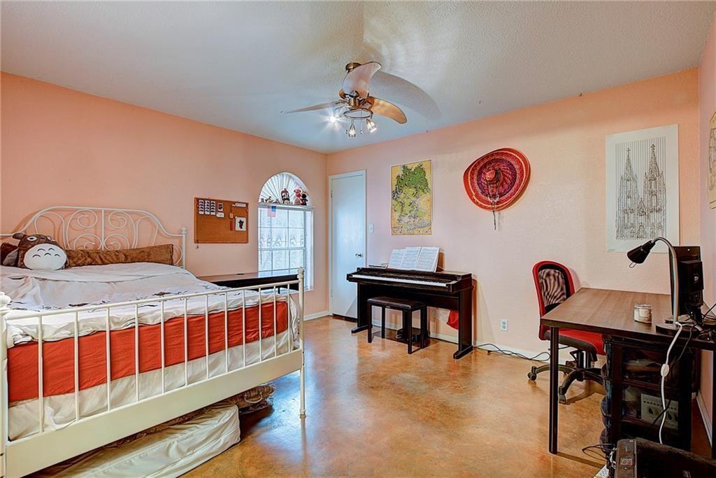 910 Duncan Lane, Unit 7 Austin, TX 78705 - Photo 4 of 20 a bedroom with furniture and a window