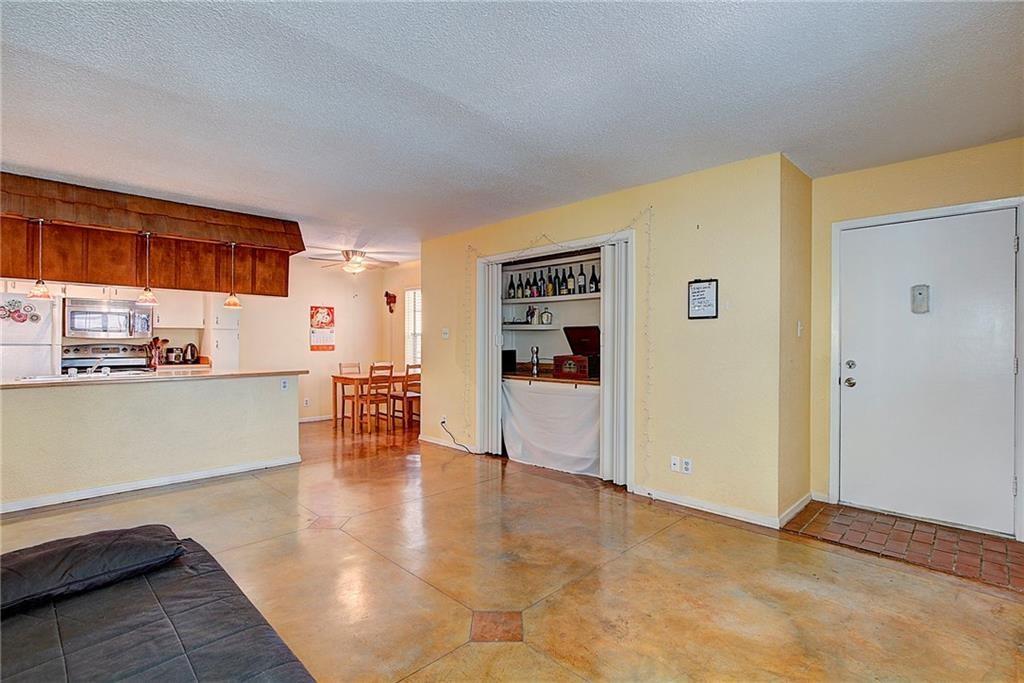 910 Duncan Lane, Unit 7 Austin, TX 78705 - Photo 5 of 20 a view of a livingroom with furniture and an empty room