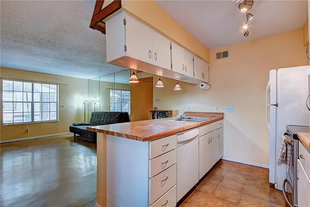 a kitchen with a sink and a refrigerator