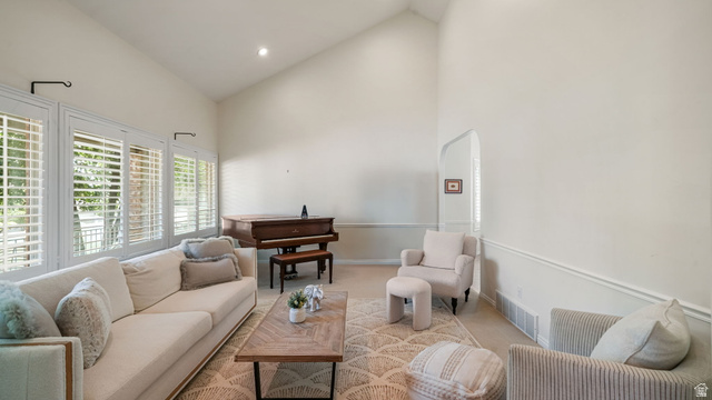 11128 South Barrett Pk Circle Sandy, UT 84092 - Photo 4 of 36 Living area featuring vaulted ceilings, a series of windows with plantation shutters, wainscoting, and recessed lighting