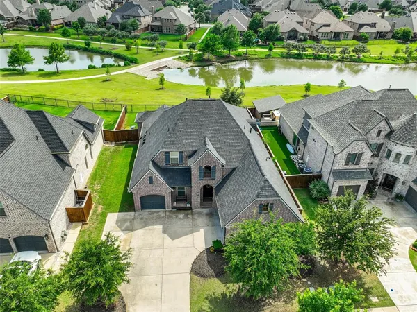 an aerial view of a house with a garden and a yard