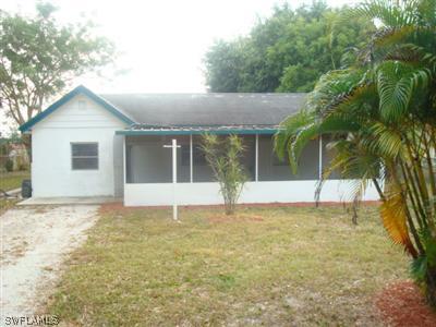 1122 Patterson Road Cape Coral, FL 33909 - Photo 1 of 8 a view of a house with a yard and potted plants