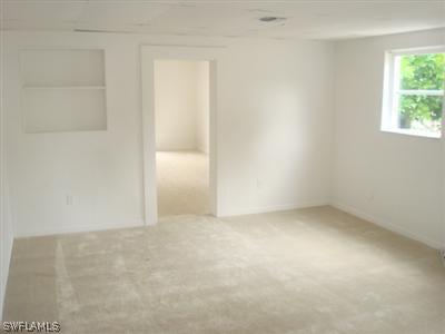 1122 Patterson Road Cape Coral, FL 33909 - Photo 3 of 8 an empty room with a window