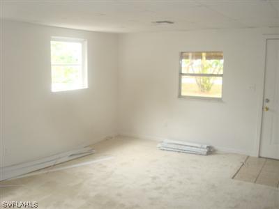 1122 Patterson Road Cape Coral, FL 33909 - Photo 4 of 8 an empty room with a window