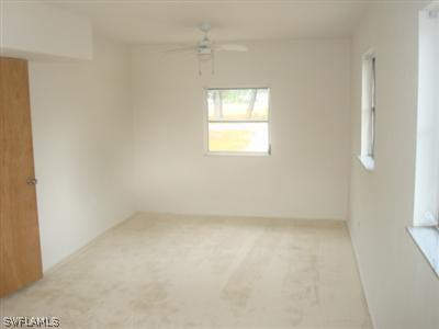 1122 Patterson Road Cape Coral, FL 33909 - Photo 6 of 8 an empty room with a window
