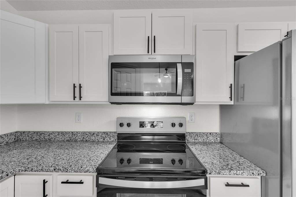 23711 Southwest Rainbow Lakes Boulevard Dunnellon, FL 34431 - Photo 11 of 27 a stove top oven sitting inside of a kitchen