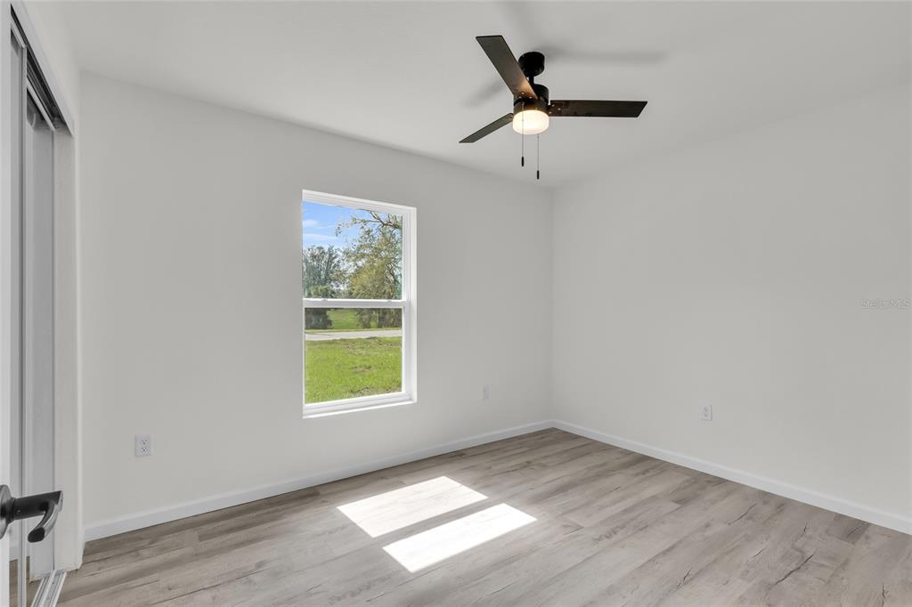 23711 Southwest Rainbow Lakes Boulevard Dunnellon, FL 34431 - Photo 13 of 27 an empty room with a window