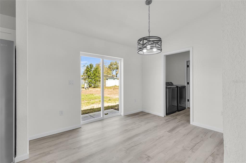 23711 Southwest Rainbow Lakes Boulevard Dunnellon, FL 34431 - Photo 20 of 27 a view of an empty room with a window and wooden floor
