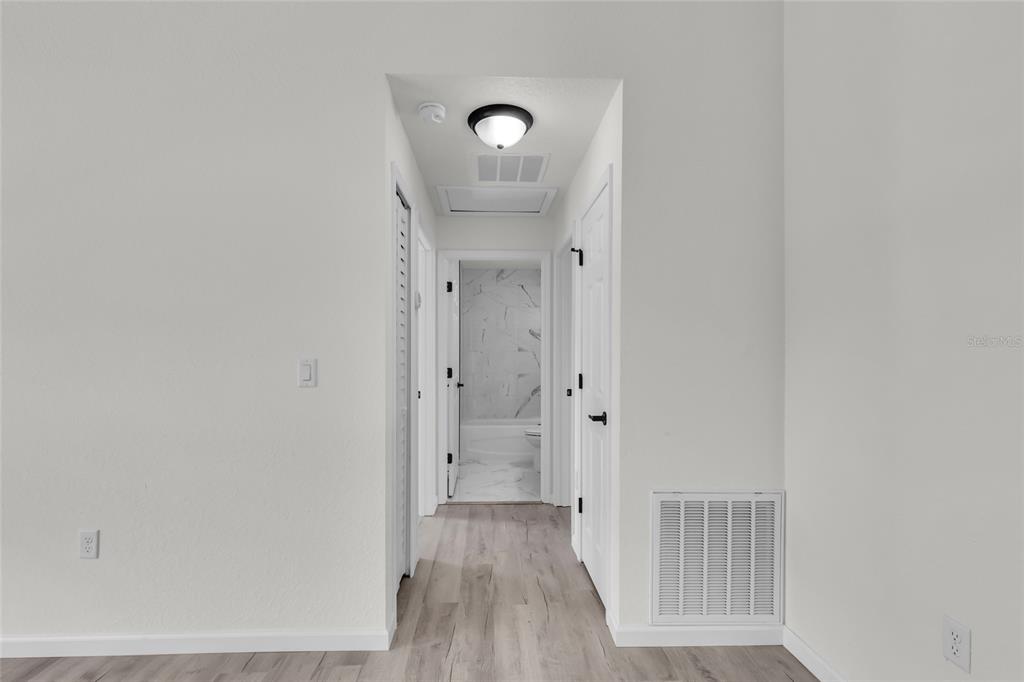 23711 Southwest Rainbow Lakes Boulevard Dunnellon, FL 34431 - Photo 25 of 27 a view of a hallway with wooden floor
