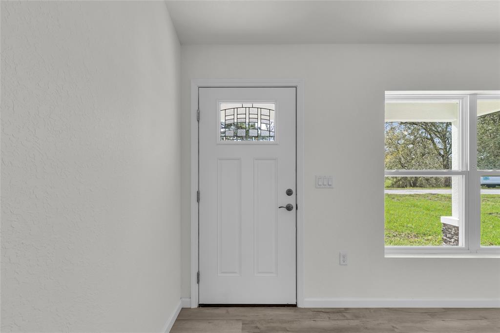 23711 Southwest Rainbow Lakes Boulevard Dunnellon, FL 34431 - Photo 5 of 27 a view of an empty room with a window