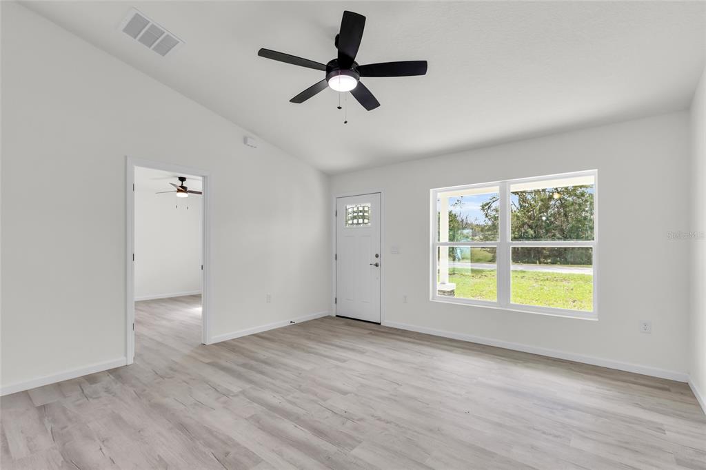 23711 Southwest Rainbow Lakes Boulevard Dunnellon, FL 34431 - Photo 7 of 27 a view of an empty room with a window