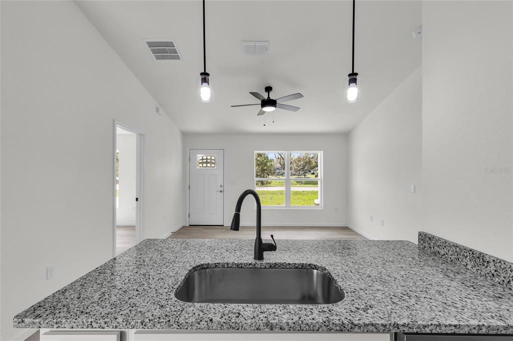 23711 Southwest Rainbow Lakes Boulevard Dunnellon, FL 34431 - Photo 10 of 27 a kitchen with a sink a counter top space and a window