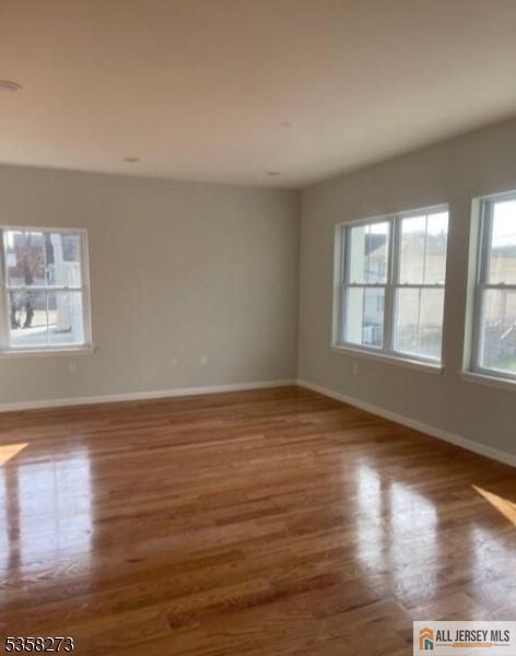 476 Meade Street, Unit 1A Orange, NJ 07050 - Photo 6 of 11 a view of an empty room with wooden floor and a window