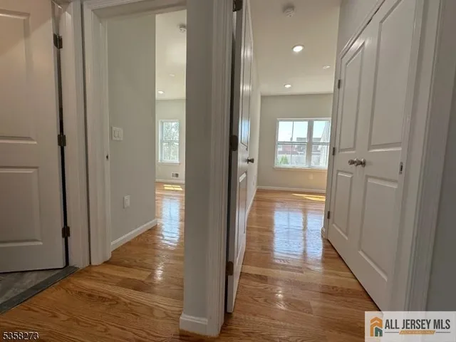 a view of a hallway with wooden floor