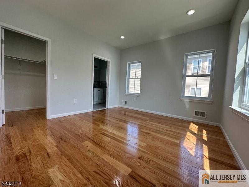 476 Meade Street, Unit 1A Orange, NJ 07050 - Photo 8 of 11 a view of empty room with window and wooden floor