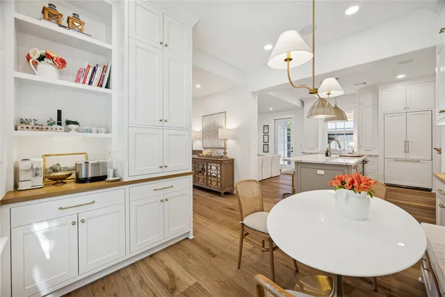 a kitchen with stainless steel appliances a refrigerator and wooden floor