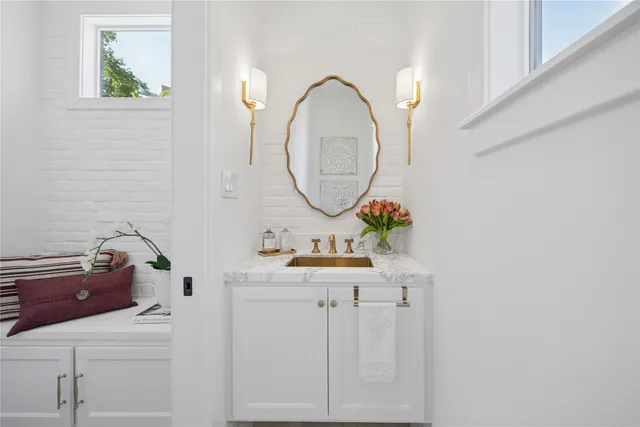a white painted room with a potted plant