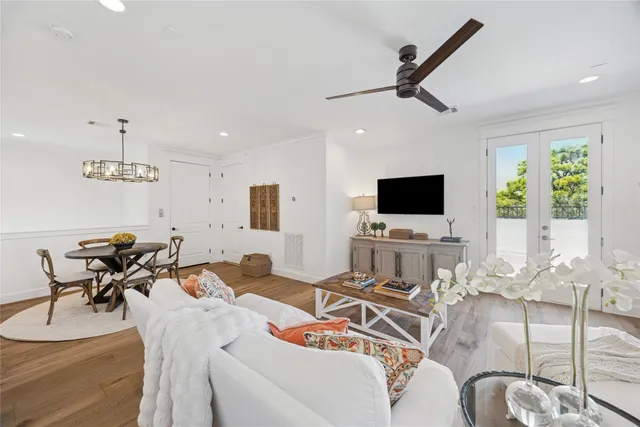 a living room with furniture a rug and a chandelier