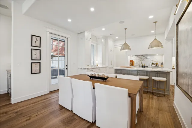 a kitchen with kitchen island stainless steel appliances a stove a sink a refrigerator and cabinets