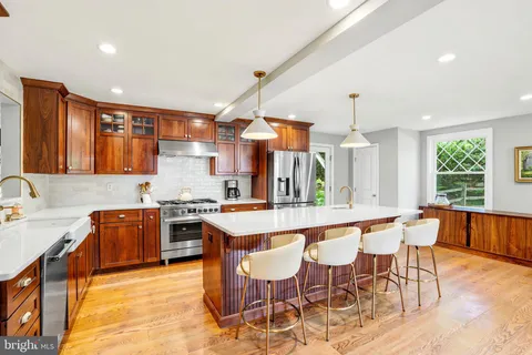 a large kitchen with a table and chairs