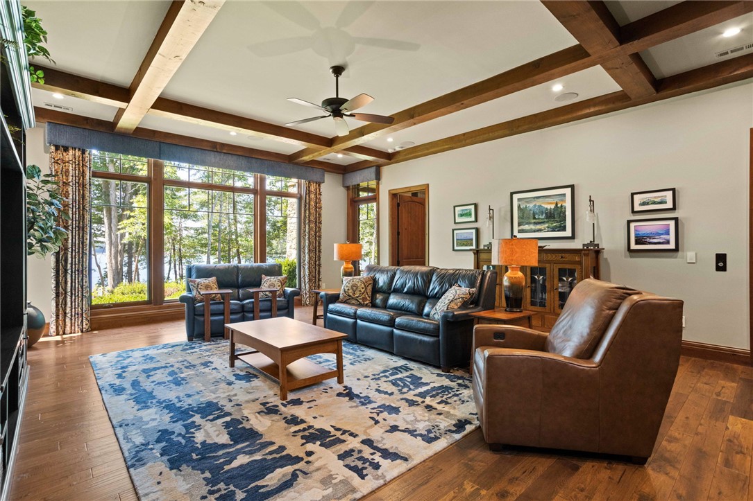 236 Palmer Way Sunset, SC 29685 - Photo 20 of 46 Exposed wood beams adorn the ceiling, complementing rich hardwood flooring and a picturesque view of the lake.