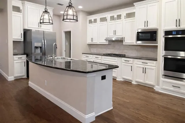 a view of a room with wooden floor windows and glass door