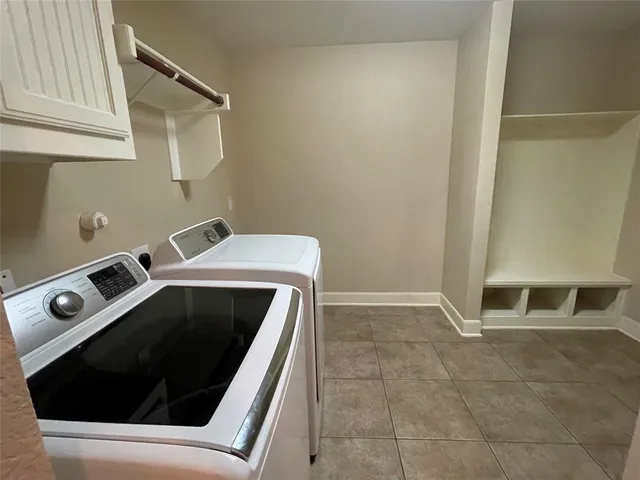 a patio with a table and chairs under an umbrella
