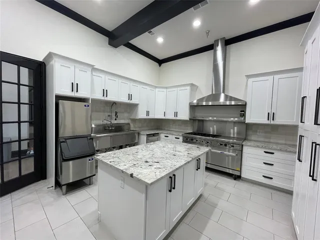 a front view of a house with a yard and potted plants