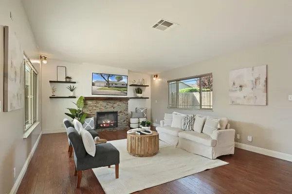 a living room with furniture and a fireplace