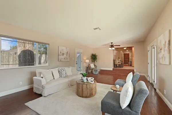 a living room with furniture and wooden floor
