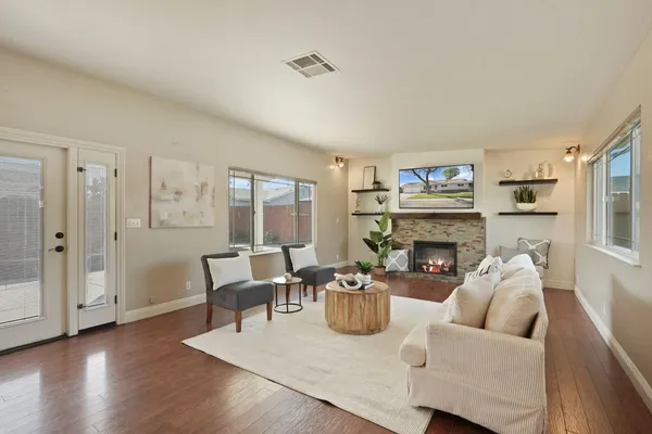 a living room with furniture and a fireplace