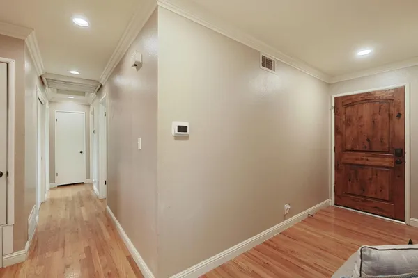 a view of a hallway with wooden floor