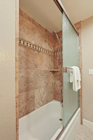a bathroom with a bathtub and a shower