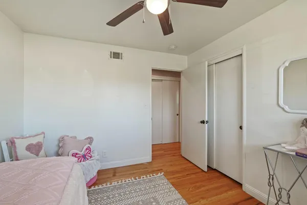 a room with a bed and a rug