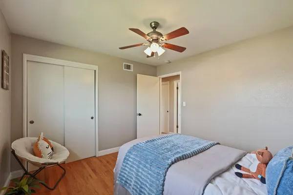 a bedroom with a bed and a chandelier
