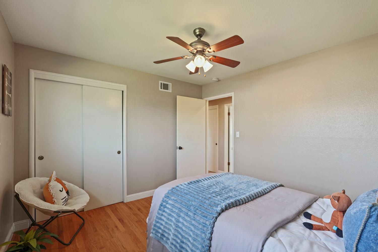 916 6th Street Ripon, CA 95366 - Photo 21 of 34 a bedroom with a bed and a chandelier