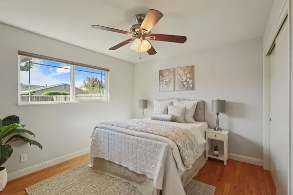 a bedroom with a bed and wooden floor