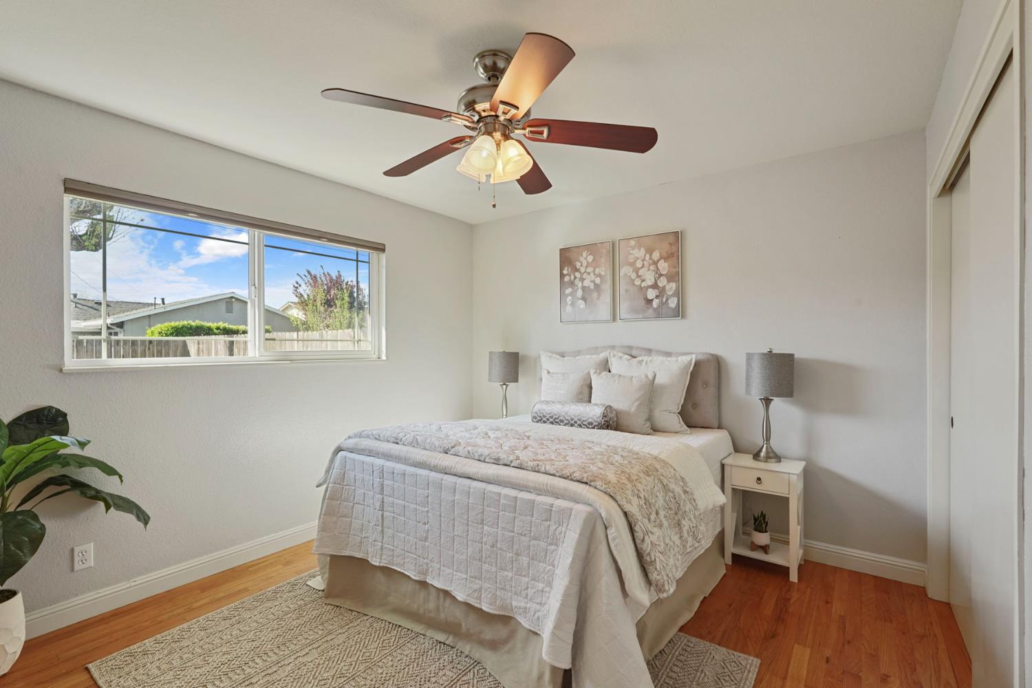 916 6th Street Ripon, CA 95366 - Photo 22 of 34 a bedroom with a bed and wooden floor