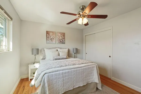 a bedroom with a large bed and a chandelier