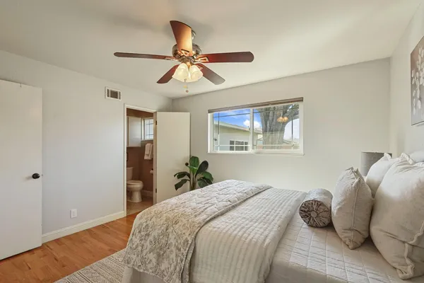 a bedroom with a bed and wooden floor
