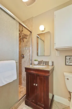 a bathroom with a sink a toilet and a mirror