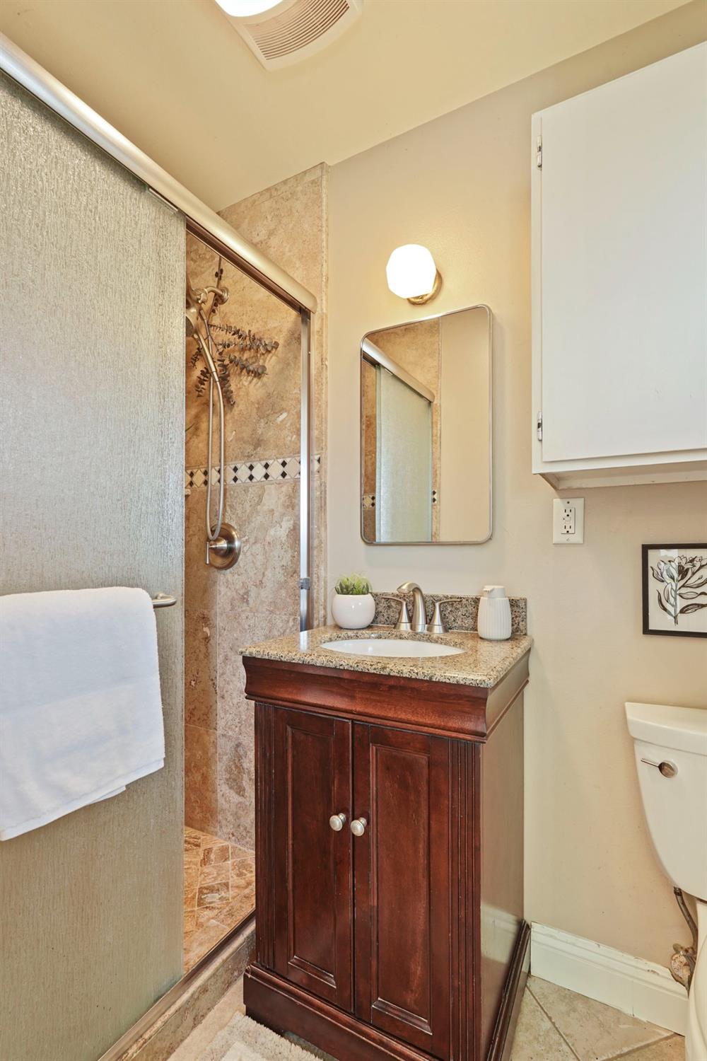 916 6th Street Ripon, CA 95366 - Photo 26 of 34 a bathroom with a sink a toilet and a mirror