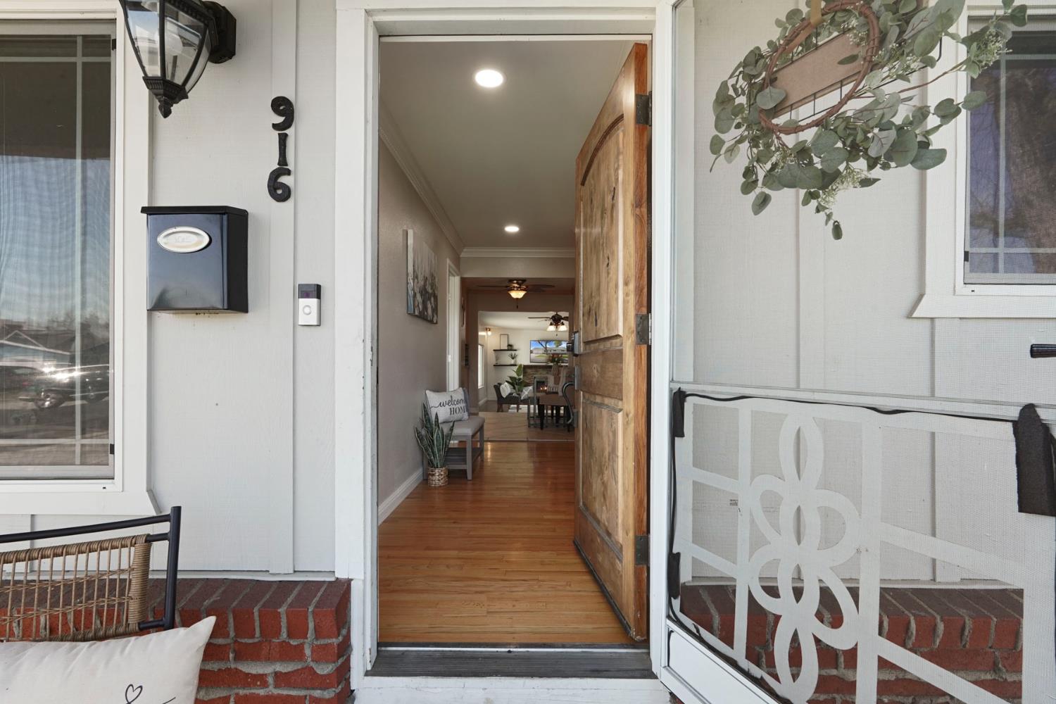 916 6th Street Ripon, CA 95366 - Photo 3 of 34 a view of a hallway with wooden floor and windows