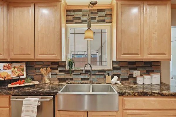 a kitchen with granite countertop a sink and a stove